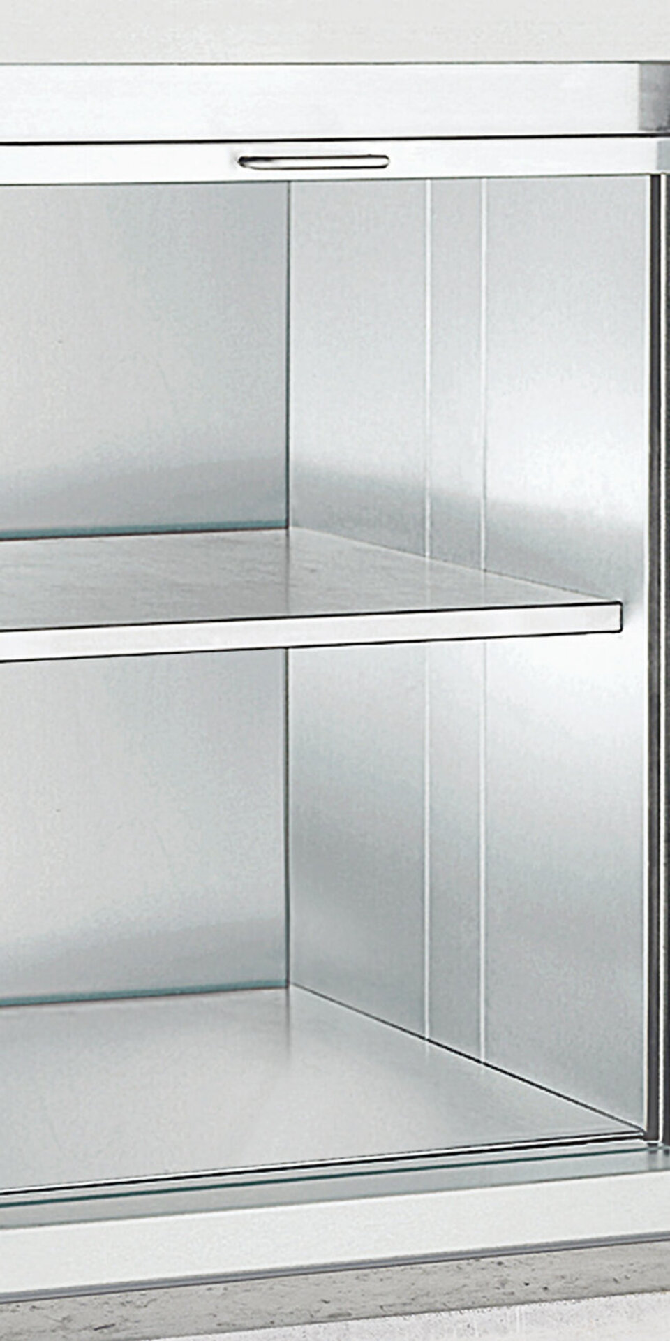 Ein Speiseaufzug aus Edelstahl mit zwei Regalen und einer Schiebetür, der in eine Wand eingebaut ist.